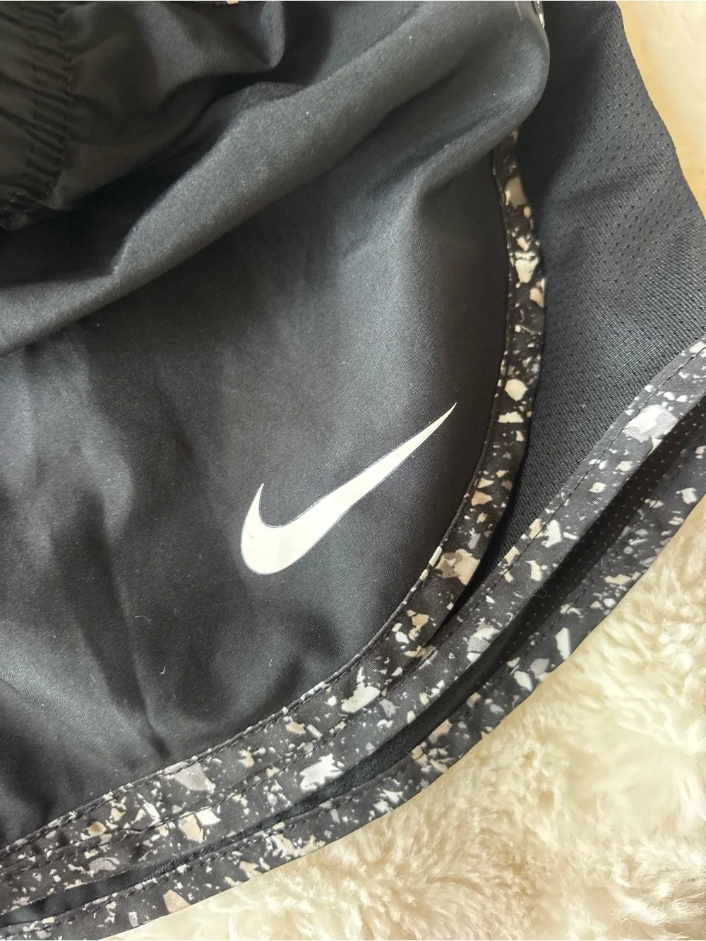 Nike Black Athletic Shorts with White Swoosh and Speckled Trim